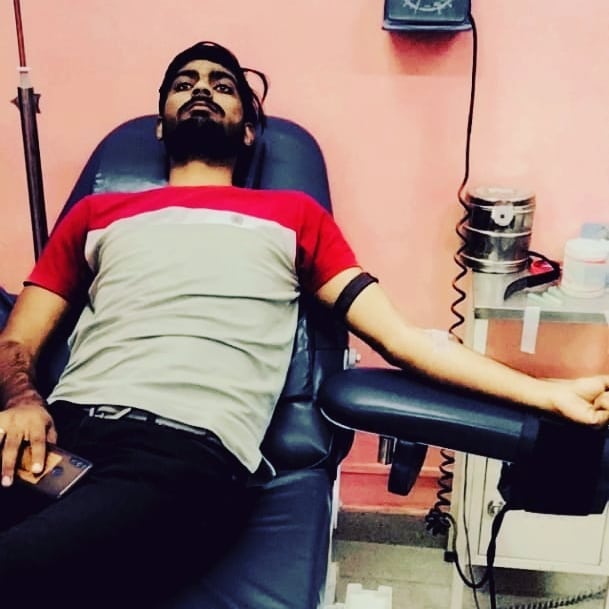 Young donor contributing blood for seva