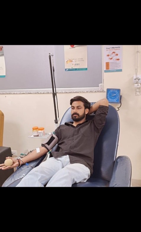 Donor squeezing ball during blood donation