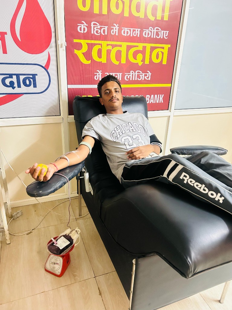 Donor with blood bag during seva